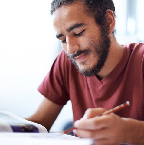 Young man studying for the GED exam