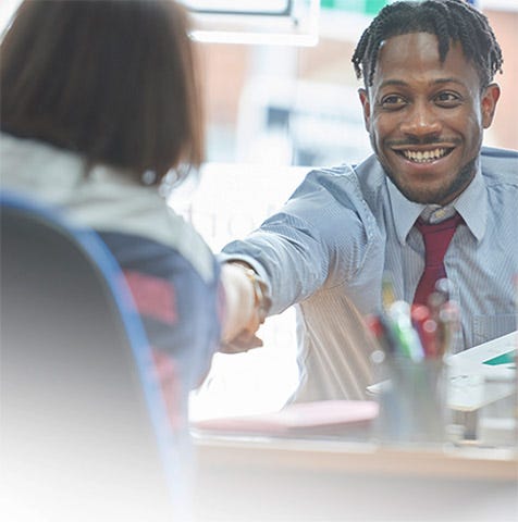 Volunteer offering tax preparation services to a low-income individual